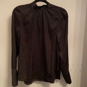 Black silky top with polka dots.